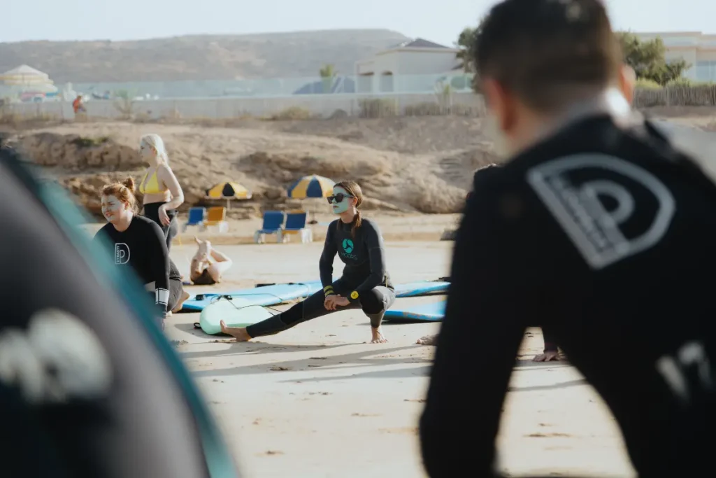 Surf camp warmup stretching session in Morocco
