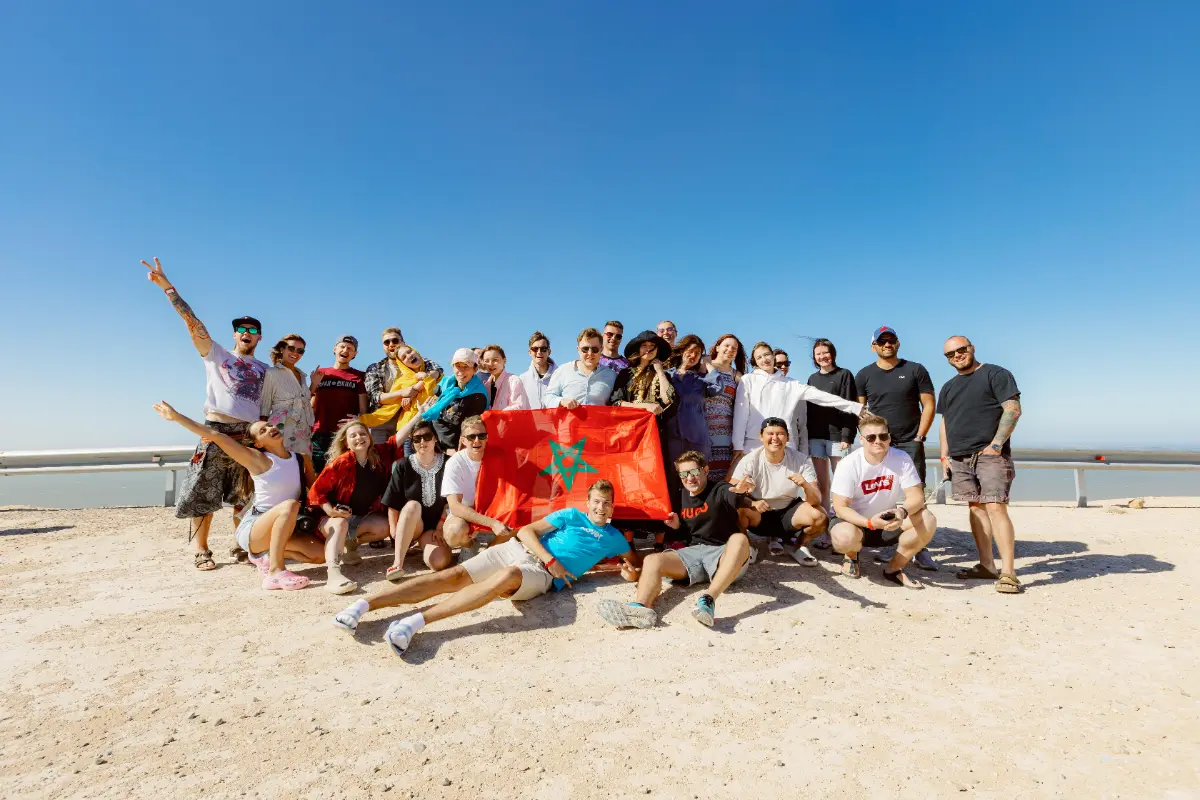 Surf camp group together on the beach in Taghazout, Morocco