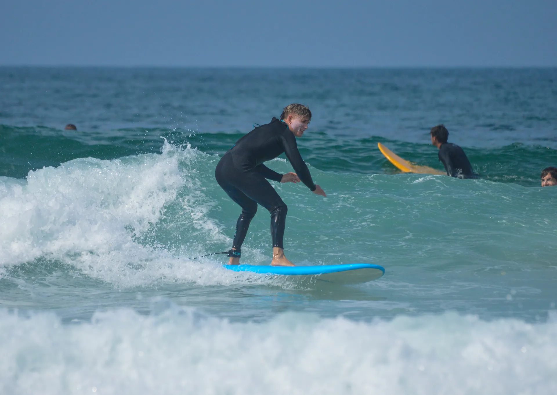 surf student riding wave blue board taghazout 2 Taghazout Surf Camp