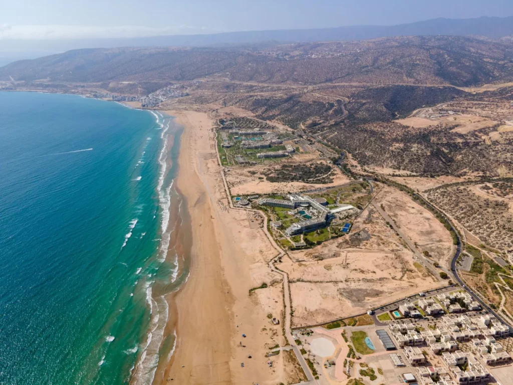 Aerial view of the long sandy beach and coastline of Taghazout Bay, Morocco